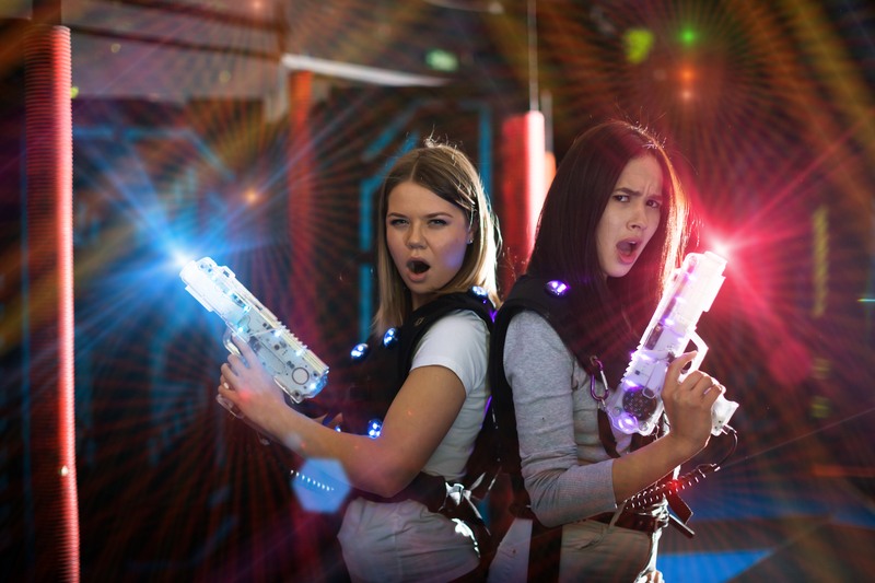 young women playing laser tag